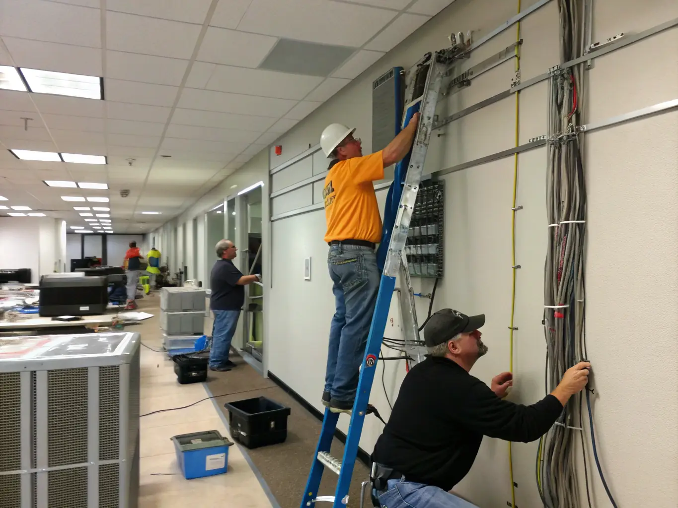 A construction site where technicians are installing new network cables and equipment, representing the immediate start of projects made possible through financing.